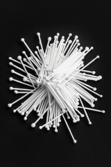 Sticker - A collection of white cotton buds scattered on a dark background