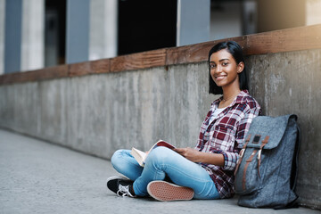 Poster - Girl, college student and book on ground for portrait at campus with reading, smile or knowledge for education. Woman, studying and happy on sidewalk with research, info and learning at university