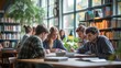 © acnaleksy - University students sitting together at table with books and laptop. Happy young people doing group study in library.