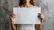© Максим Рудько - Woman Holding Blank A2 Poster Mockup on Isolated Gray Background