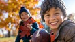 © Jafree - Young boy with a football in sunny autumn park. Concept of childhood, outdoor play, fall season, youth sports