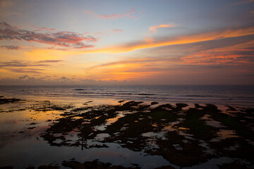 Beautiful view of Uluwatu Beach at sunset in Bali, Indonesia	
