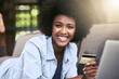 © JorSons/peopleimages.com - Black woman, ecommerce and credit card on sofa in house for portrait, relax and online shopping. Female person, laptop and digital payment for internet subscription, membership or fast food discount