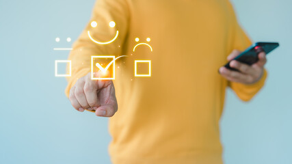 Fototapete - Customer hand touch a virtual screen showing a happy smile icon, indicating service satisfaction. Business concept involves assessment, customer service testimonials, and feedback, rated very good.