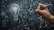 © Creative_Bringer - Hand drawing lightbulb and icons on chalkboard, creative ideas, closeup, soft light