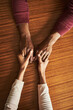 © TamJam/peopleimages.com - Couple, holding hands and above for comfort in home for care, connection and empathy for mental health. People, support and partner for help with kindness, bonding and solidarity for grief on table