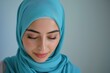 © BabyEyes - Portrait of a Young Woman in a Blue Hijab