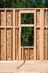 Wall Mural - Wood framing started on new home construction job site, exterior walls with windows and subfloor

