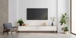© Monirknn - Smart TV on the white wall in living room with armchair,minimal design.