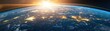 © Chanoknan - Sunrise over the Earth viewed from space, highlighting vibrant city lights and the curvature of the planet against the dark expanse of space.