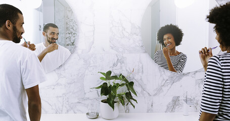 Wall Mural - Brushing teeth, love and mirror with couple in bathroom of home together for morning routine. Reflection, smile or wake up with happy man and woman in apartment for dental care or oral hygiene