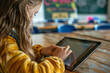 © Firn - Young girl child learning with digital tablet notebook in school. Concept for modern technology in education