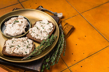 Wall Mural - Toasts with Cod liver Spread pate on a plate. Orange background. Top view. Copy space