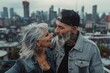 © Sladjana - A fashionable older couple with grey hair and tattoos, sharing a moment on a city rooftop with a skyline view