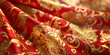 © Kashifmajeed - The image shows a close-up of red fabric with gold and yellow decorative patterns. There are several layers of fabric, and the patterns include swirls and dots.