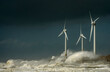 © Westend61 - Storm waves smashing over wind turbines