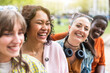 © Westend61 - Cheerful female friends sitting together and laughing