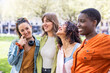 © Westend61 - Happy multiracial friends standing side by side at park