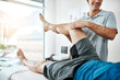 © peopleimages.com - Man, knee injury and physiotherapist working in consulting room, rehabilitation with exercise. Male people, office and together for physiotherapy service with health insurance or joint support