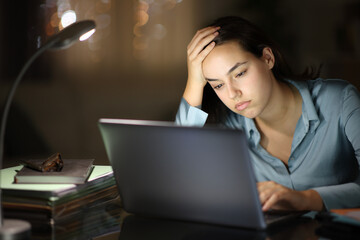 Overwhelmed worker working online in the night