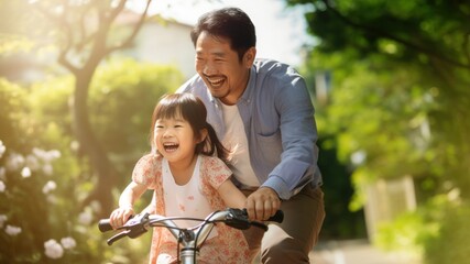 Canvas Print - photo of an Asian father helps young daughter ride a bicycle.