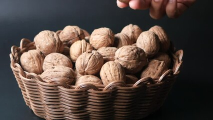 Canvas Print - hand pick natural walnuts from a bowl 