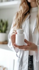 Poster - Female doctor holding a white medicine bottle in a bright modern office. Medical care and pharmaceutical concept.