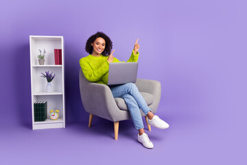 Wall Mural - Full body photo of young woman sit armchair office point empty space dressed stylish green clothes isolated on violet color background