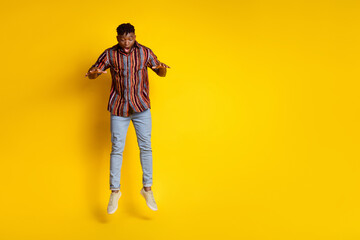 Full body portrait of nice young man jump fall empty space wear shirt isolated on yellow color background