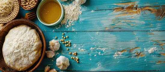 Poster - A blue wooden table displays compressed yeast near dough ingredients, with a perfect copy space image.