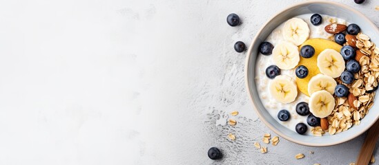 Aufkleber - Delicious oatmeal with banana, blueberries, walnuts, and milk in a bowl on a white marble surface, with copy space image.