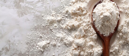 Poster - Flour and wooden spoon against a plain background with available copy space image.