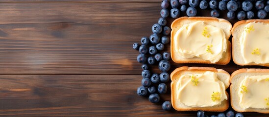 Poster - Top view of delectable toasts with butter and blueberries on a rustic grey wooden table, with room for text in the image