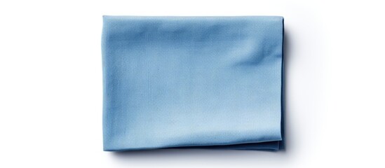Poster - A folded blue linen napkin with copy space image isolated on a white background in a flat lay perspective.