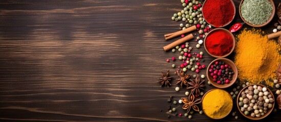 Poster - Colorful spices arranged on a wooden table with space for text, as seen from above in a copy space image.