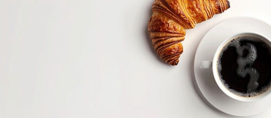 Leinwandbilder - Croissant beside black coffee on a white table with copy space image.