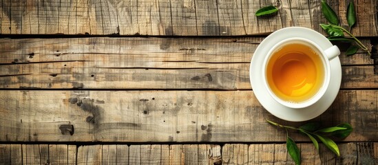 Sticker - Wooden table hosts a cup of fragrant green tea with ample copy space image.