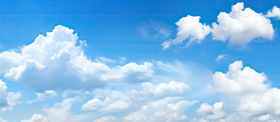 Poster - Sunny weather with bright blue sky and fluffy white clouds, ideal as a nature-themed background. The serene image portrays a heavenly landscape with ample space for text or design elements.