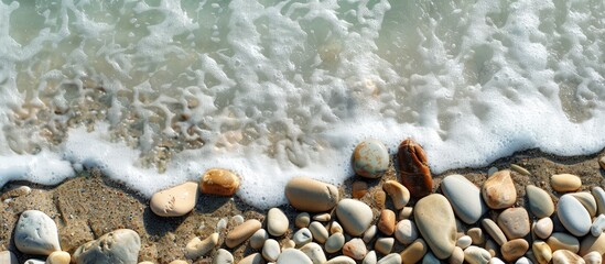 Poster - Spanish beach with stones featuring a copy space image.