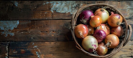 Poster - Onions arranged in a basket on a rustic wooden surface with copy space image.