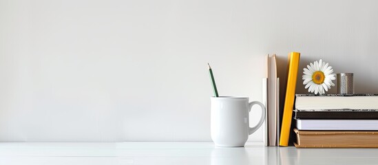 Fototapete - White desk with books, coffee mug, and pencil arranged for mockup workspace with copy space image.