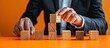 © HN Works - A businessman rotates wooden blocks, altering Lead off to Lead on symbol on an orange table, illustrating the concept of business decisions. Ample copy space image included.