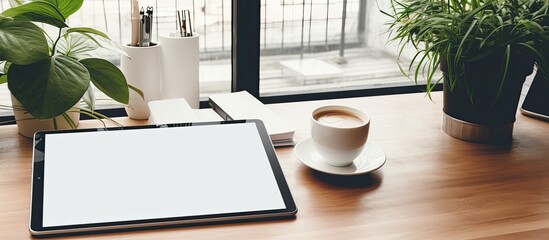 Leinwandbilder - Female freelancer working from home with a mock-up tablet and supplies on a grey table background, with a copy space image visible.
