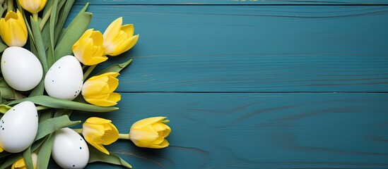 Fototapete - Top-down view of yellow tulips, blue and white eggs in a nest on an Easter-themed background with ample copy space image.