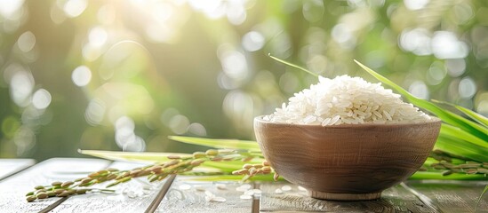 Poster - Selective focus with blurred background on a wooden table featuring rice and paddy, with space available for copying an image.