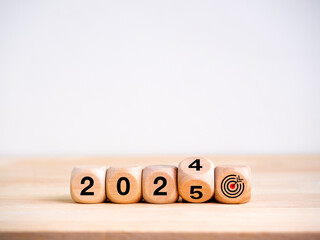 Poster - 2025 happy new year with goal and successful banner concepts. Flipping the 2024 to 2025 year calendar numbers with target dart icon on wooden cube blocks isolated on wood table and white background.