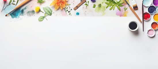 Poster - Artist's creative workspace with watercolor and artistic tools laid out on a white backdrop, seen from above in a flat lay style with room for text or an image.