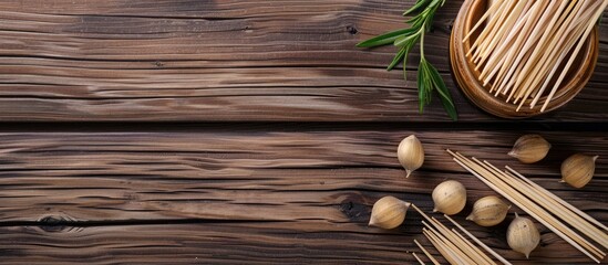 Poster - Wooden background with disposable toothpicks and holder arranged in a flat lay composition, featuring ample space for text in the image.