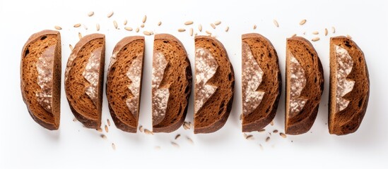Poster - Top view of freshly baked rye bread slices on a white background with copy space image.