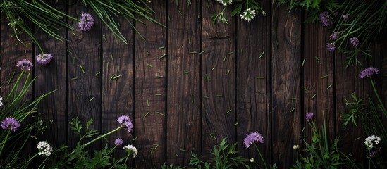 Wall Mural - Dark wooden backdrop with blooming chives and pansies, creating an elegant aesthetic for a copy space image.